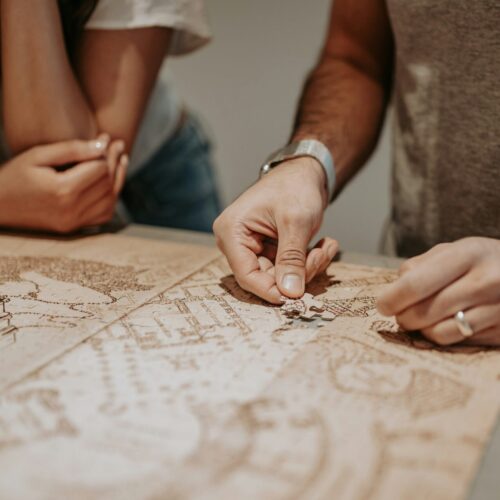 an engaged couple doing a puzzle to symbolize preparing for married life