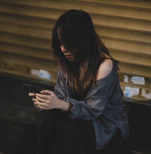 woman after a breakup looking at pictures of ex