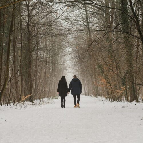 a couple walking hand in hand after infidelity therapy