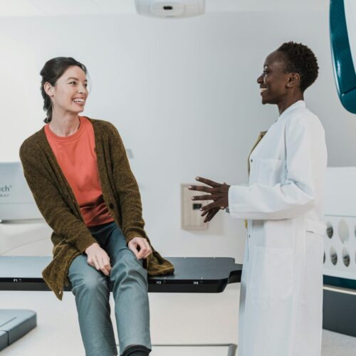 Smiling doctor and patient showing positive healthcare relationship after healing from medical trauma with EMDR
