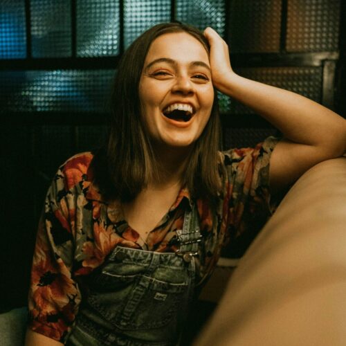 Genuinely happy woman laughing, showing renewed joy and freedom after EMDR for PTSD treatment