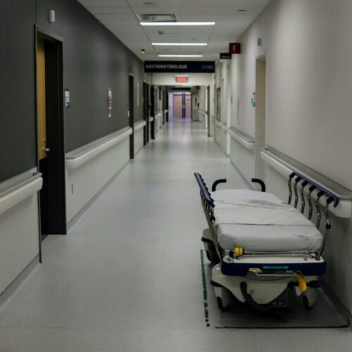 Empty hospital hallway with stretcher, representing the clinical environment that triggers anxiety after medical trauma