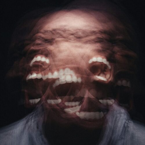 Blurred motion image of man's face showing multiple exposures, representing disorientation and flashbacks in PTSD before EMDR treatment
