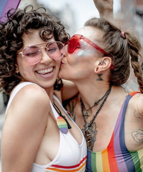 Couple kissing at Pride celebration, representing authentic love and community in LGBTQ therapy in Philadelphia