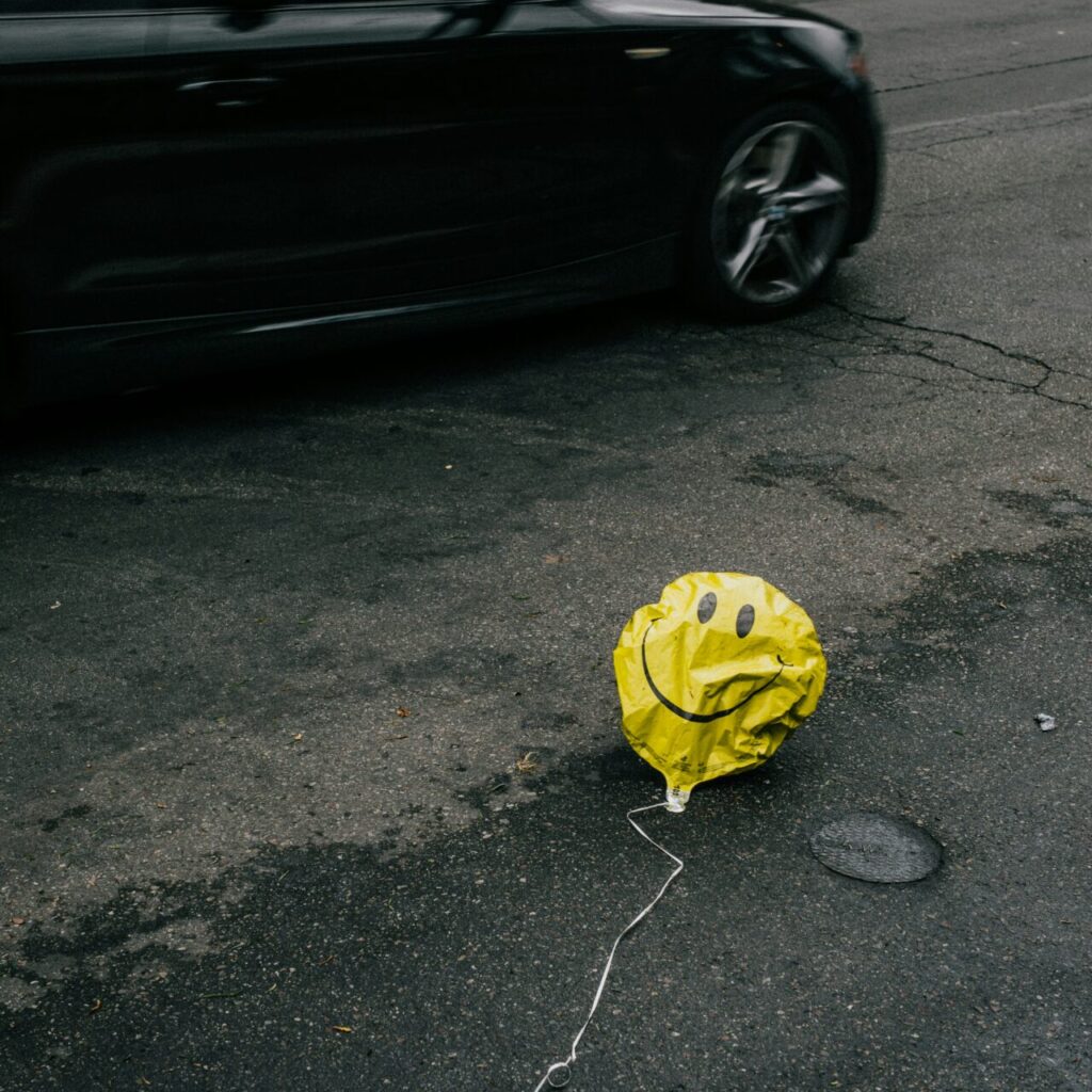 a happy balloon on the ground symbolizing pretending to be happy but actually needing depression therapy