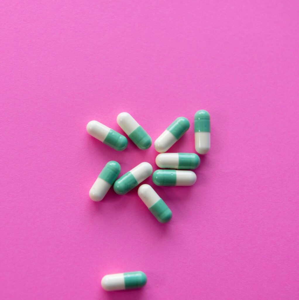 antidepressants on a pink background symbolizing the choice between therapy and medication for depression